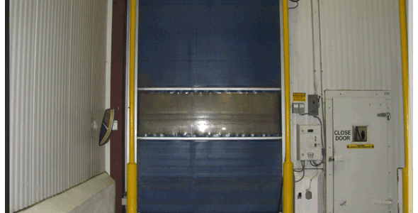 A blue and yellow door in a warehouse.