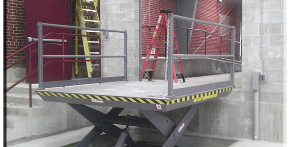 A lift platform in a building with a ladder on it.