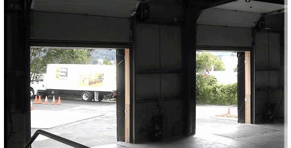 A picture of a garage door with a truck in it.