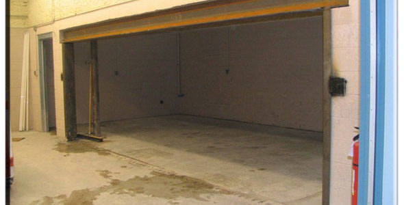 A garage with a door that is open.