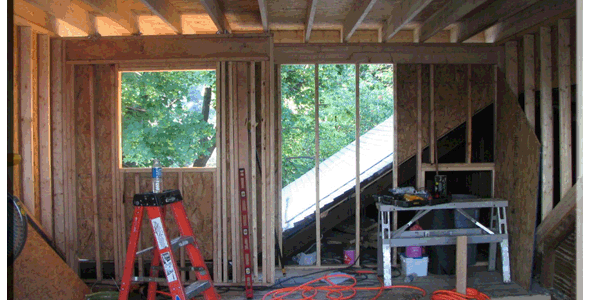A room being built with wood framing and a ladder.