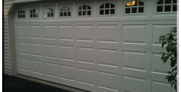 A white garage door with a window.